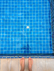 A white flower floating on the water in a swimming pool.