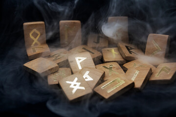smoke swirls around wooden runes	
