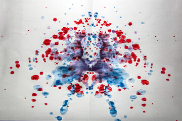 A lot of multi-colored gouache paint created a clown pattern and many different shapes in the...