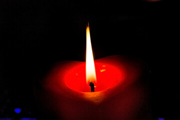 Red candle burns with fire close-up	
