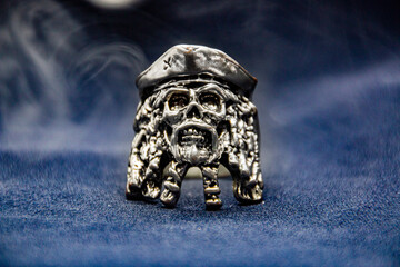 Pirate skull ring with smoke in the background	
