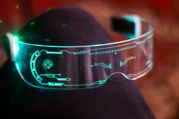 Close-up of futuristic eyeglasses luminous in aquamarine color with transparent glass	
