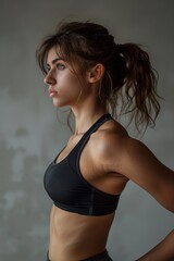 Obraz premium Athletic Woman Posing in Black Sports Bra