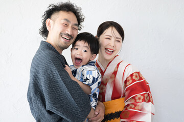 Family of friendly smiling Japanese in yukata, white background, traditional Japanese clothing.