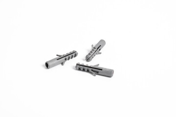 Grey plastic dowels for screws on a white isolated background