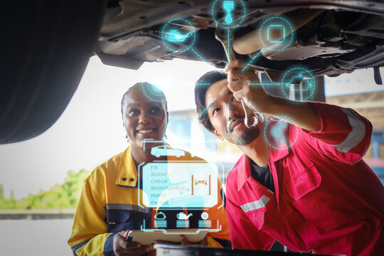 Car mechanic inspects car using technology and computer show resault at virtual screen.