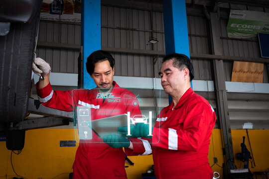 Car mechanic inspects car using technology and computer show resault at virtual screen.