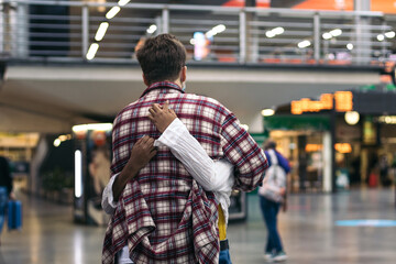 Reunited at last!: Young couple meeting at the station after a trip - obrazy, fototapety, plakaty