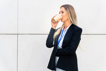 Modern business woman having a takeaway coffee