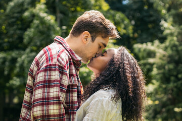 First love: young lovers kissing in the park