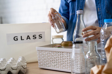 Man separating glass in container for recycling