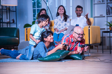Indian multigenerational family playing video game at home
