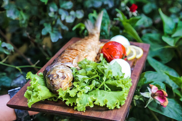 Wooden Cutting Board With Lettuce and Fish