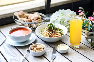 Table With Food Bowls and Glass of Orange Juice
