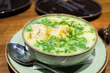 Traditional georgian chicken soup. Chikhirtma served in ceramic bowl with coriander herb