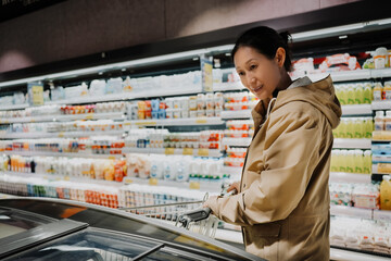 Woman Shopping in Supermarket Dairy Aisle
