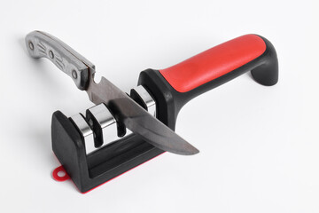 Knife and knife Sharpener isolated on white background. Manual knife sharpening, Kitchen tools