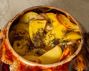 Potatoes baked in a cauldron. The chef prepares fried potatoes in a wood-burning oven in nature....