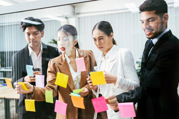 Group of successful Asian businessmen teamwork. Brainstorm meeting with sticky paper notes on the...