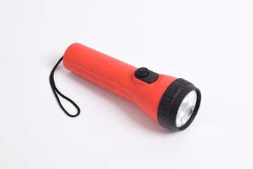 Red color flashlight isolated on white background. Red Battery-powered flashlight