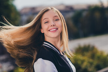 Photo portrait of charming teen woman fluttering hair toothy smile dressed stylish uniform clothes...