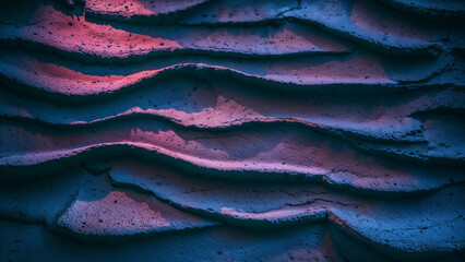 Powder paint neon blue and pink wavy grooves rough rock texture wall pattern.