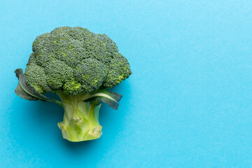 Top view fresh green broccoli vegetable on Colored background. Broccoli cabbage head Healthy or vegetarian food concept. Flat lay. Copy space