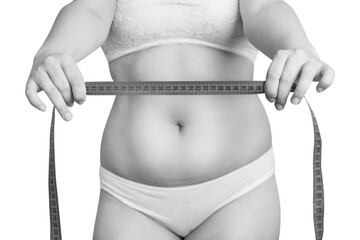 Woman shows measuring tape over fat belly background.