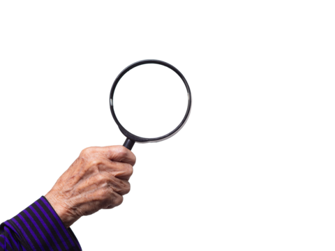 Close-up of an old woman's hand holding a magnifying glass against a transparent background.