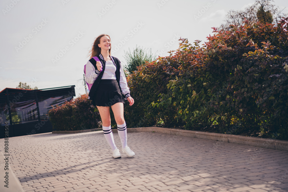 Poster photo of dreamy good mood girl wear school uniform walking college enjoying sunny weather outside ur