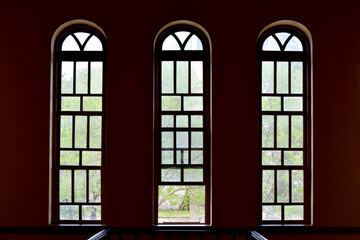 A room with three oval domed windows exudes elegance and charm, bathing the space in natural light while offering picturesque views. Its architectural beauty invites tranquility and inspiration