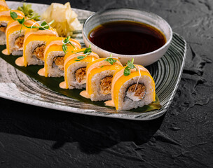 Elegant sushi rolls platter with dipping sauce