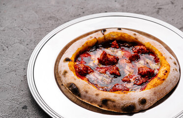 Artisan pepperoni pizza on white plate