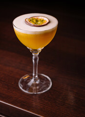 Elegant passion fruit cocktail on wooden