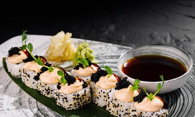 Gourmet sushi roll platter with caviar and soy sauce