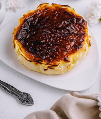 Homemade basque burnt cheesecake on elegant table setting