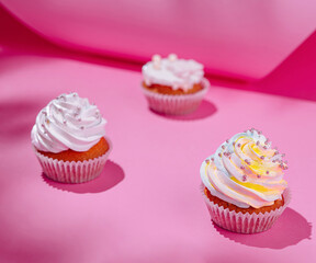 Festive cupcakes on pink background