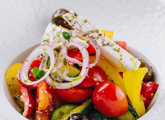 Fresh greek salad in white bowl