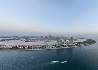 Aerial panoramic view of Palm Jumeirah islands during sunset in Dubai