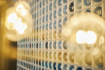 A mosaic of blue-toned buttons arranged in a pattern on a wall