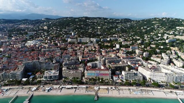 Helictoper aerial view of Cannes beach and boulevard the city is located on French Riviera in Alpes-Maritimes department and it is known for its association with the rich and famous and its luxury 4k