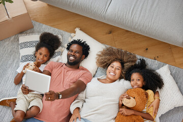 Family, portrait and tablet playing games on living room floor in home for entertainment, bonding...
