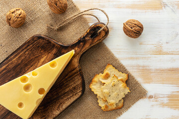 Assortment of different cheese types on white wooden table. Cheese background.