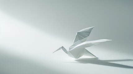 Naklejka premium Origami bird. Animal made of paper on a bright background. Paper folding art.