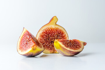 Ripe cut fig on white table. Food concept.