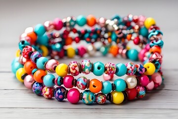Kids handmade beaded jewelry. Necklaces and bracelets made from multicolored beads and pearls. DIY bracelet beads. Children's needlework. Creativity and hobby. Art activity for ... See More
