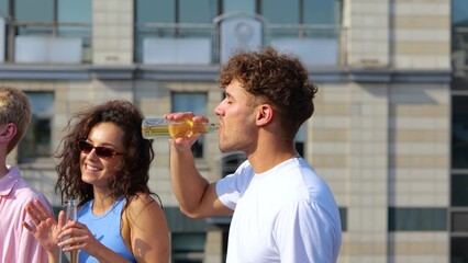 Close up of young carefree happy people standing outdoors on sunny day having fun at party on the...