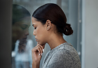 Anxiety, depression and business woman at window of office for grief, emotion or mental health....