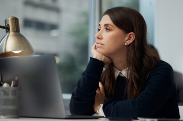 Business woman, laptop and thinking in office with burnout, tired and bored for work or job....