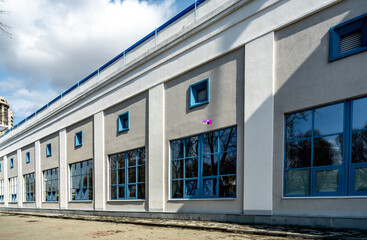 A long stone building with large windows.